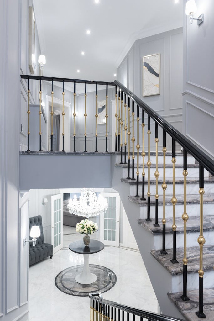 A sophisticated modern interior featuring a stylish staircase with decor elements.